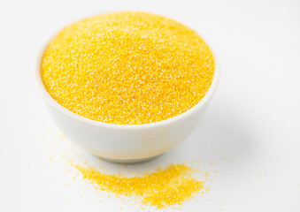 Heap of Polenta or Cornmeal Flour in a white bowl. Ground  Dried Corn or Corn Grits. Top View, Copy Space. 