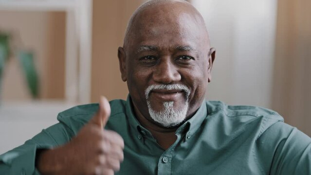 Portrait of happy elderly african american man smiling old senior putting two thumbs up positive grandfather looking at camera showing hand gesture of approval agreement recommendation support sign