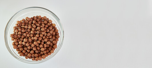 Granola in a transparent bowl on a white background. Healthy food.