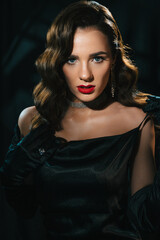 Portrait of woman in style of classic retro Hollywood movie of 1950s. Elegant young girl with a stylish hairstyle and makeup. Concept of vintage female looking