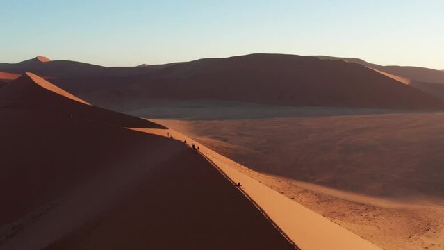 Aerial drone footage of Dune 45 in Sossusvlei, Namibia during sunset