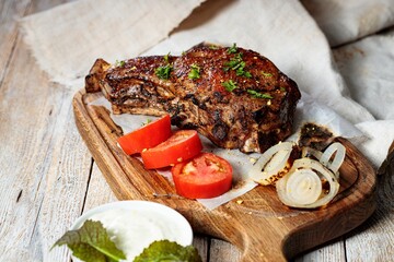 Close-up Grilled steak. Appetizing roasted meat with vegetables and herbs