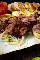 Appetizing grilled meat. Assorted vegetables and mushrooms. Close-up. Vertical shot