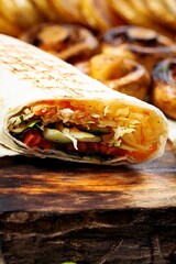 Traditional shawarma. Turkish street food. Eastern fast food. Doner kebab with garnish. Close-up. Vertical shot