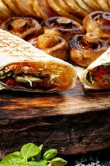 Traditional shawarma. Turkish street food. Eastern fast food. Doner kebab with garnish. Close-up. Vertical shot