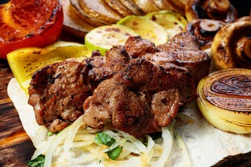 Appetizing grilled meat. Assorted vegetables and mushrooms. Close-up