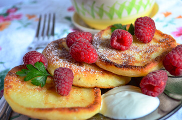 fluffy pancakes for breakfast with sour cream and raspberries