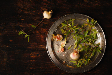 pomegranate fruits on a metal plate