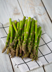 fresh green asparagus on wooden surface