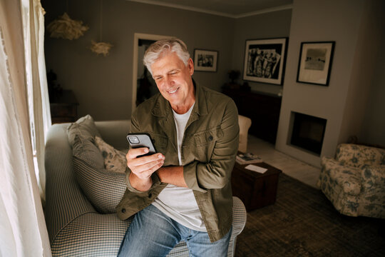 caucasian elderly man texting on cellular device 