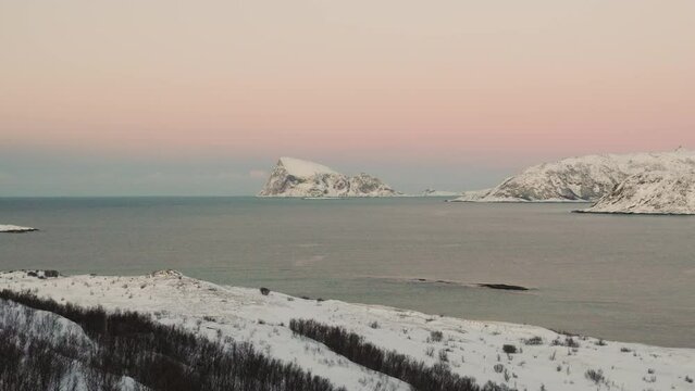 Distant View Of Snowy Mountain On Haaja Island As Seen From Kvaloya In Tromso, Norway. wide aerial