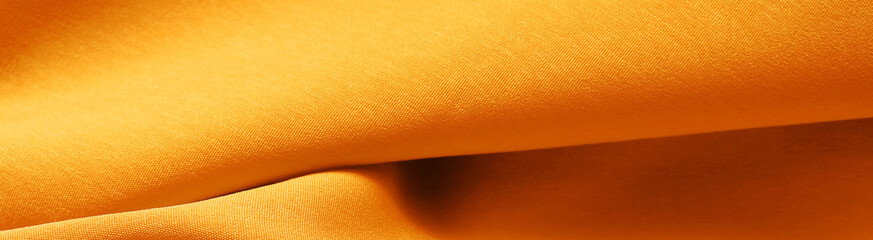 Luxurious golden silk or satin texture for background. luxurious background design.