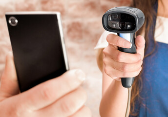 a woman reads information from a smartphone in a man's hand