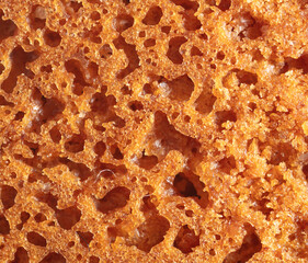 Crust on ruddy cookies as an abstract background.