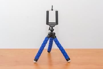 Blue mini flexible tripod for smartphones. Tripod for phone.