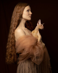 Portrait of a red-haired woman in a light scarf with a cat in profile