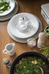 Preparation of breakfast, freshly brewed eggs, spinach, salt, sauce. Bio food, healthy raw materials. You are what you eat. All laid and laid on a wooden table.