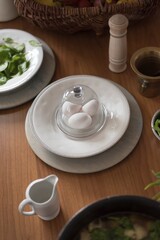 Preparation of breakfast, freshly brewed eggs, spinach, salt, sauce. Bio food, healthy raw materials. You are what you eat. All laid and laid on a wooden table.