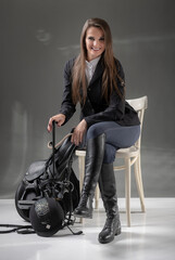 A woman in an equestrian outfit.  Riding outfit