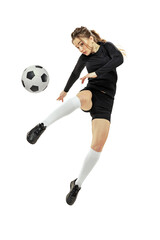 Leg kick. One sportive girl, female soccer player training with football ball isolated on white...