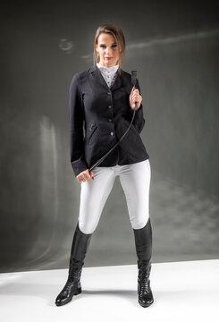 A woman in an equestrian outfit.  Riding outfit