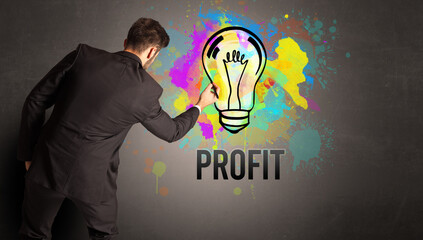 businessman drawing colorful light bulb