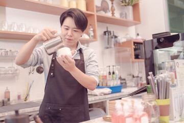 A female coffee shop business owner is busy making coffee in his shop She is serving coffee that tastes great. which the atmosphere is filled with happiness.