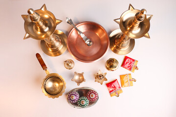 Indian traditional samai or samayee diya brass lamp on gray white background
puja stuff or puja...