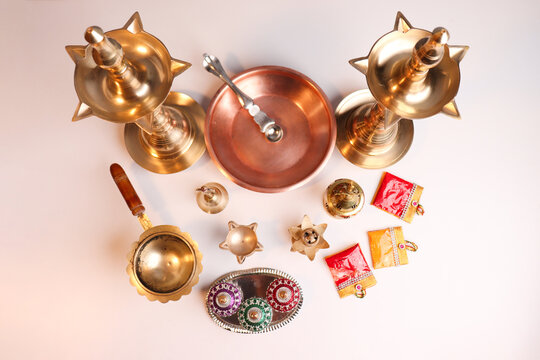 Indian traditional samai or samayee diya brass lamp on gray white background
puja stuff or puja thali with includig kalash agarbatti
diya dhup agarbatti kunku sindoor or Kumkum turmeric haldi or halad