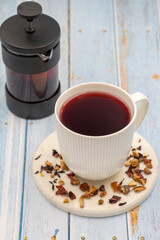 Apple Tea (Hibiscus tea) on a wooden background. Medicinal asian herbal tea. Fruit tea blended with Hibiscus, Rosehip, Orange Peel, Lemon Peel and Apple Flavor