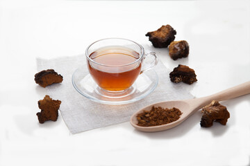 Healthy drink coffee from chaga mushroom in a glass cup on a white background. Top view. Copt spaes.