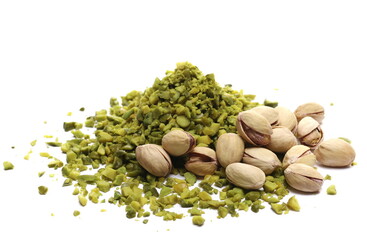 Pistachios chopped pile with nutshell isolated on white 