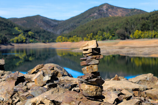 Dornes, Ferreira do Z&ecirc;zere, Portugal, February, 20, 2022. Overlaid stones on the river beach of Dornes.