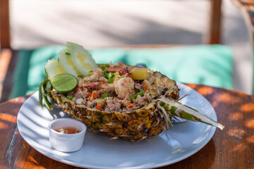 Cooked brown rice with vegetables and shrimp in a pineapple