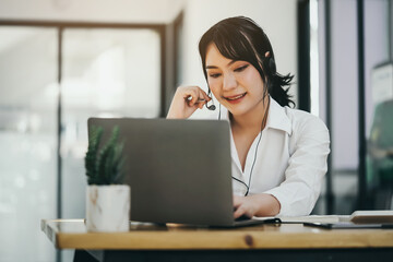 Asian women call center and video conferencing with clients in the workplace.