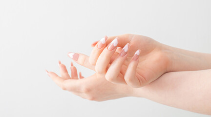 female hands with beautiful long nails with  manicure with  heart pattern