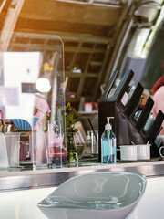 Blue alcohol gel bottle for hand cleaning to prevent the spreading of the Coronavirus (Covid-19) on counter to service for customers at cafe or coffee shop. Healthcare concept. New normal lifestyle.