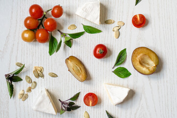 Charcuterie board of assorted cheeses, vegetables and appetizers. Above Top view table scene on a...