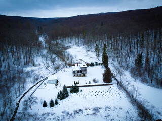 Posiadłość pod lasem zimą widok z góry z drona