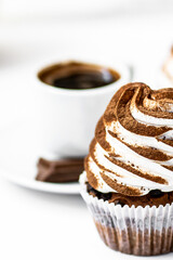 Black coffee with cupcakes and muffins. Spice cupcakes with creamcheese frosting decorated with a cocoa