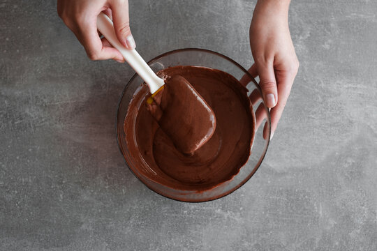woman preparing chocolate mousse close-up top view