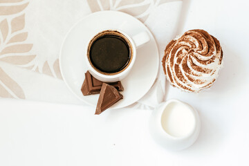Dark chocolate and cocoa chocolate cupcakes with a cup of hot black coffee. Space for text
