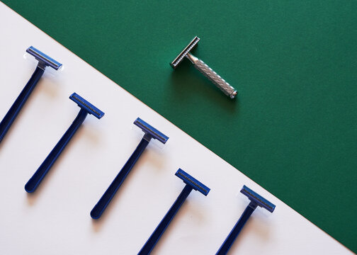 A Comparison Of Plastic And Eco-friendly Razors On A Green Flat Lay