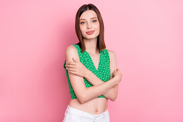 Naklejka premium Photo of young charming lady hug herself dream enjoy bodycare soft isolated over pink color background