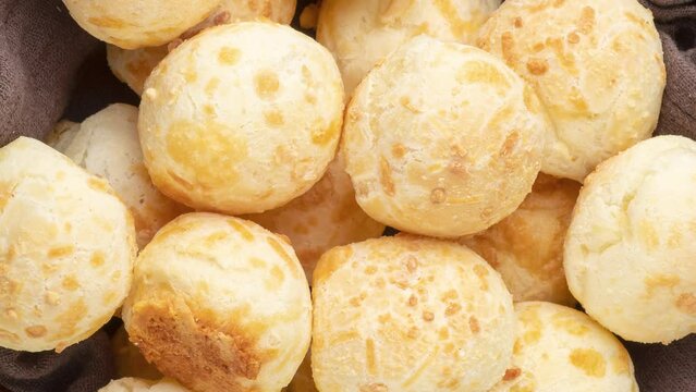 Typical brazilian cheese bun in a basket over wooden table