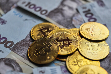Ukrainian money with Cryptocurrency Coins.Bitcoin BTC, Ukrainian hryvnia, Tether USDT cryptocurrency physical coin