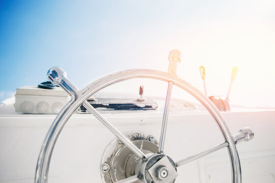 Modern boat steering wheel on luxury yacht with sunlight. Concept banner sea travel