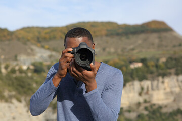 Man with black skin takes photos with dslr camera