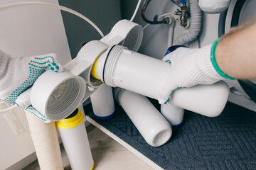Plumber working replaceable dirty used aqua filter for filtration of reverse osmosis water