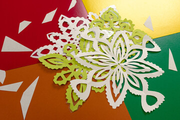 Cut colored paper on the table. Educational games with colored paper in kindergarten